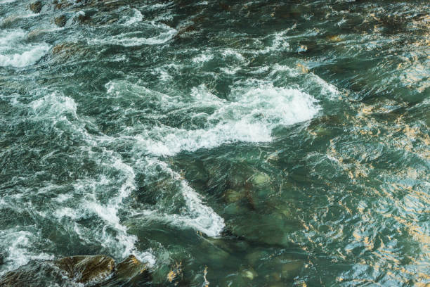 istock natural background with water, fast mountain river in the mountains 1129181865