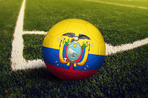 Ecuador ball on corner kick position, soccer field background. National football theme on green grass.