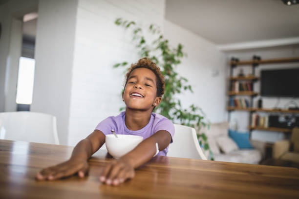 istock Cheerful child eating breakfast from a bowl 1129182078