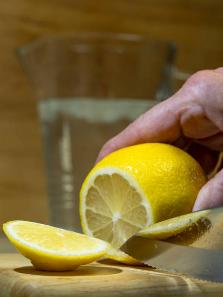 istock Sliced lemon Citrus Limon Wood Cutting Board Water Pitcher 1129182100