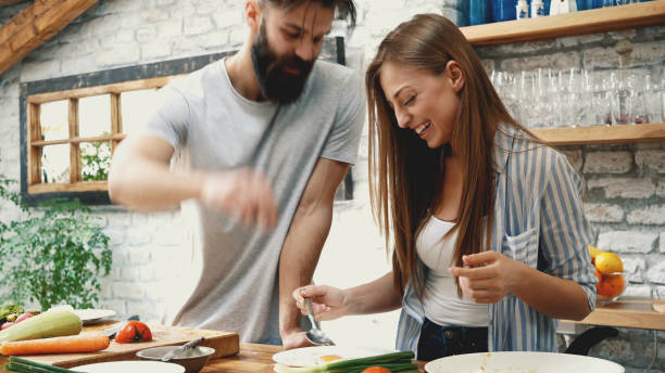istock Young couple making dinner together at home 1129182123