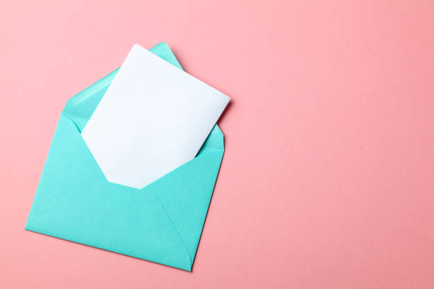 istock Green envelope and blank letter on pink background. mock-up. 1129182443