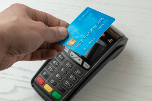 istock POS terminal, Payment Machine with credit card isolated on white background. Contactless payment with NFC technology. 1129183677