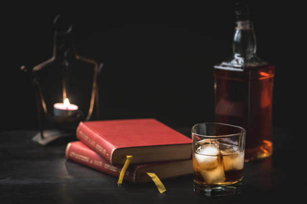 istock a glass of whiskey and a good book 1129184020