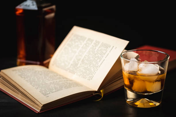 a glass of whiskey and a good book - time to relax - photo in retro style