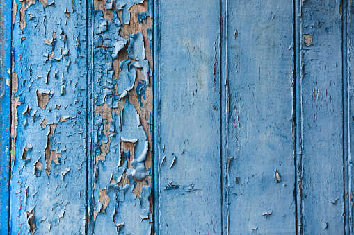 Texture on the ancient wooden blue door.