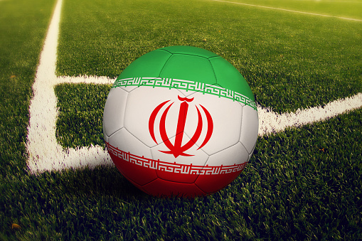 Iran ball on corner kick position, soccer field background. National football theme on green grass.