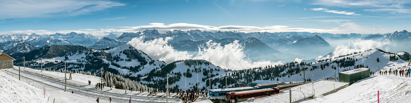 Rigi Kulm, Switzerland - January 4, 2019: Tourists enjoying their views on Swiss Alps from top of Mount Rigi in canton of Schwyz, Switzerland during sunny winter day