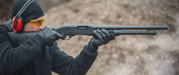 istock Combat shotgun shooting training. Long gun, pump gun and scattergun 1129185660