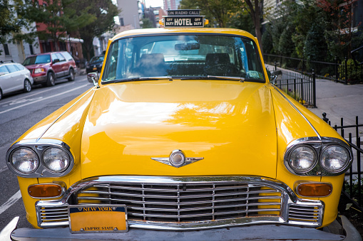 Straight on view of an old fashioned taxi.