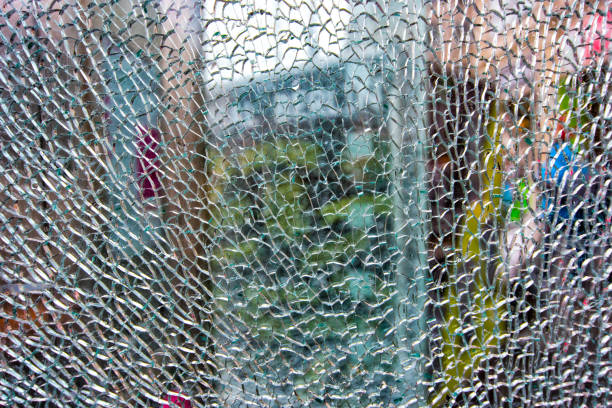 istock background texture of broken glass with cracks damaged by vandals 1129186940