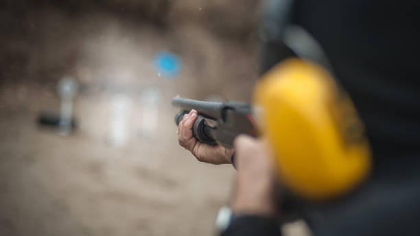 istock Combat shotgun shooting training. Long gun, pump gun and scattergun 1129186990