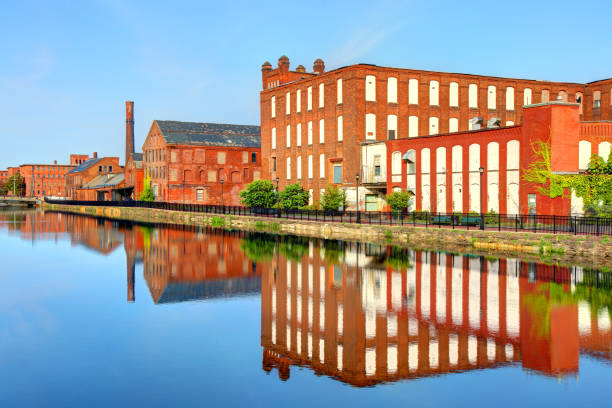 istock Mills reflecting on a canal in Holyoke Massachusetts 1129187616