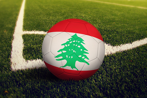 Lebanon ball on corner kick position, soccer field background. National football theme on green grass.