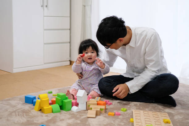 istock Father playing with baby in house 1129188138