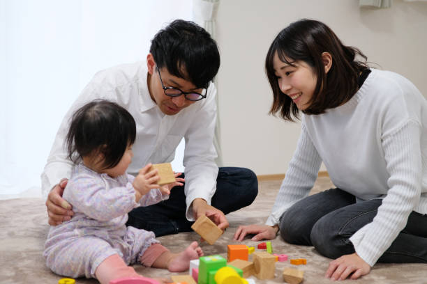 istock Father playing with baby in house 1129188139