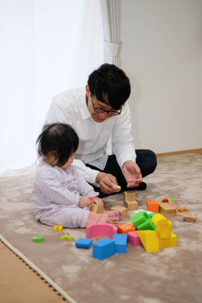 istock Father playing with baby in house 1129188158