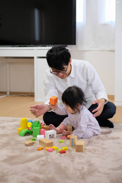 istock Father playing with baby in house 1129188163