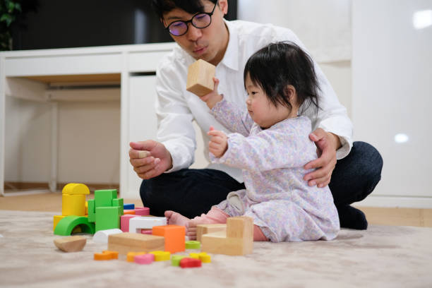 istock Father playing with baby in house 1129188166