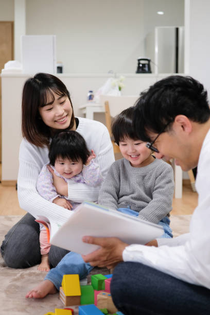 istock Father reading book to child and baby 1129188265