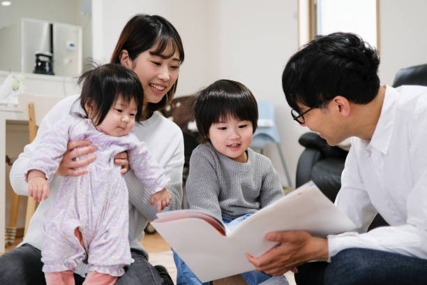 istock Father reading book to child and baby 1129188867