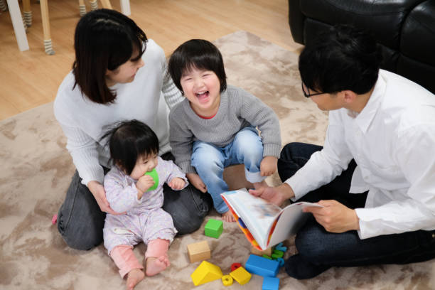 istock Father reading book to child and baby 1129188947