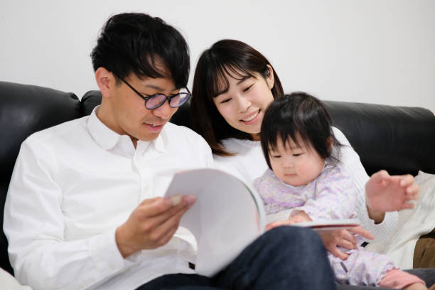 istock Father reading book to baby 1129188983