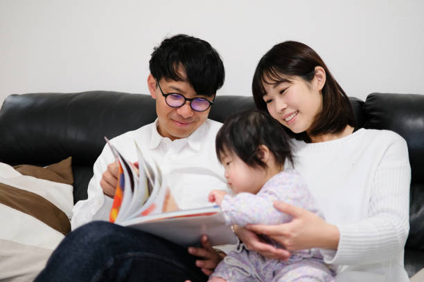 istock Father reading book to baby 1129189017