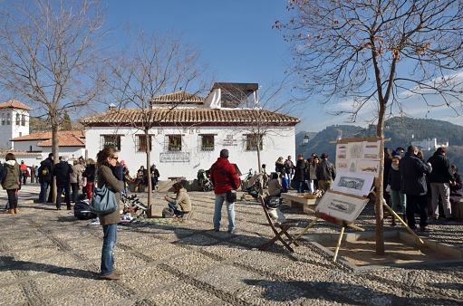 Granada, Spain - December 27, 2014: People at  Plaza of San Nicholas in the Albaicin district in Granada,  Andalusia, Spain.
