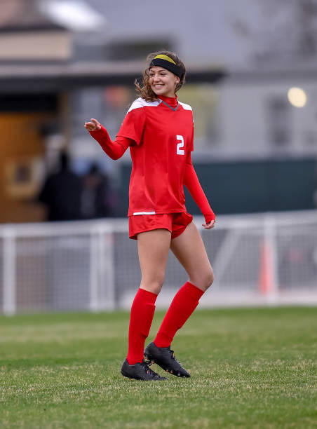 istock High School girl playing soccer 1129189683