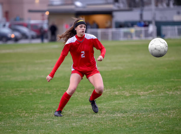 istock High School girl playing soccer 1129189740