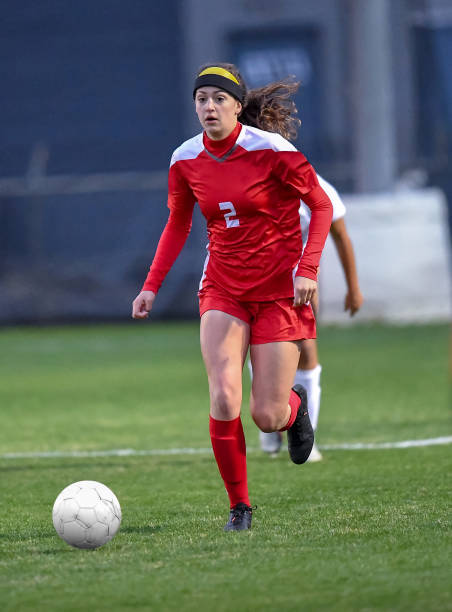 istock High School girl playing soccer 1129190285