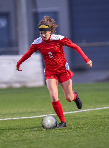 istock High School girl playing soccer 1129190288