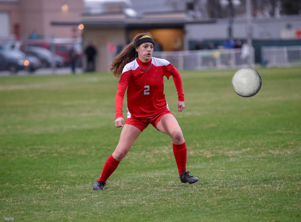 istock High School girl playing soccer 1129190290
