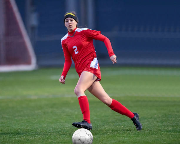 istock High School girl playing soccer 1129190317