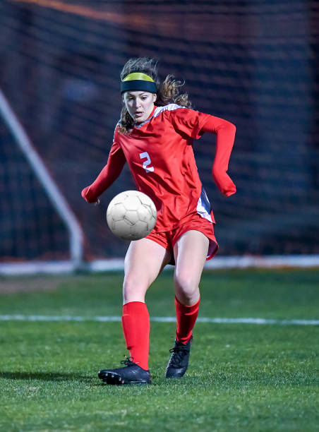istock High School girl playing soccer 1129190343