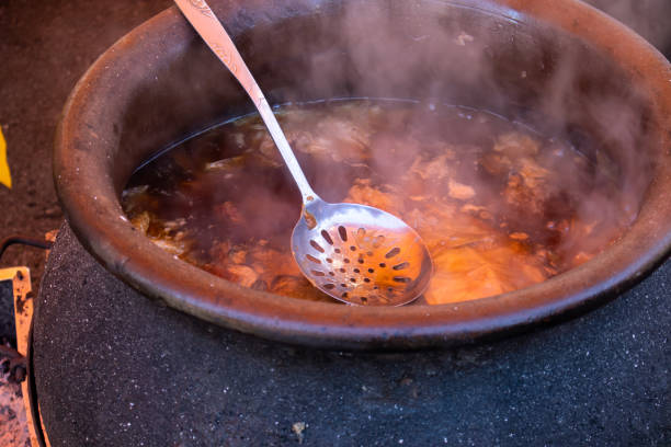 istock Preparing food outdoor direct on fire 1129190511