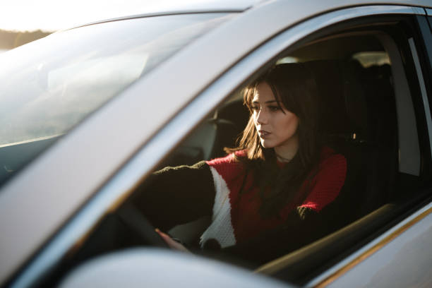 istock Young woman driving a car 1129190644