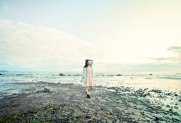 istock Young woman on seaside landscape 1129191861