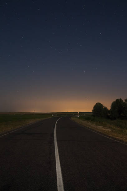 istock The road under the night sky with the stars 1129192492