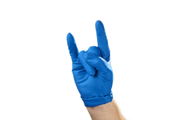 istock Hand in blue rubber glove showing gesture symbol, on white isolate. 1129192639