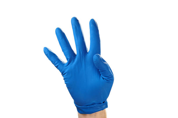 istock Hand in blue rubber glove showing gesture symbol, on white isolate. 1129192671