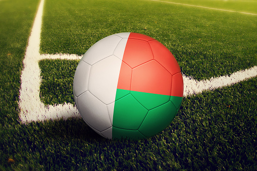 Madagascar ball on corner kick position, soccer field background. National football theme on green grass.
