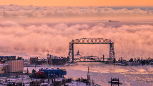 sea smoke and ice smoke coming out of lake superior duluth, minnesota lift bridge - storm lighthouse cloudscape sea imagens e fotografias de stock