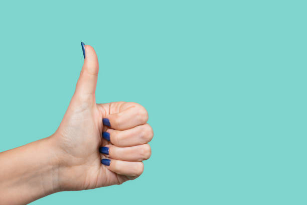 istock Woman making like gesture putting thumb up 1129195732