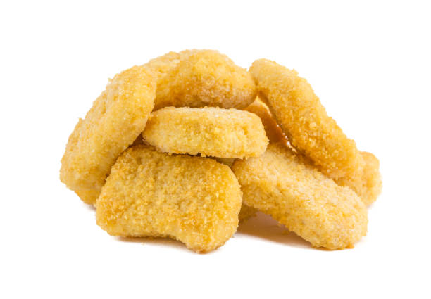istock Frozen nuggets on a white background. Several chicken nuggets in breading close-up on a white background. 1129195790