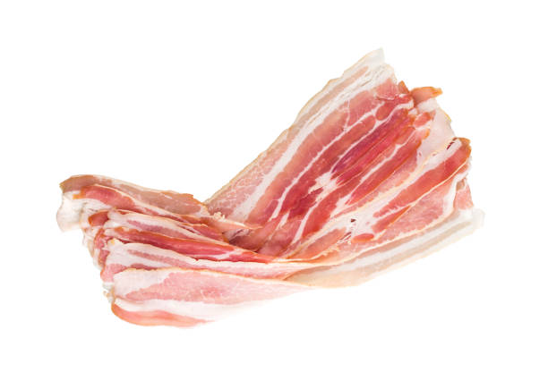 Slices of bacon on a white background. Raw bacon closeup on a white background. Slices of bacon on a white background. Raw bacon closeup on a white background. twisted bacon stock pictures, royalty-free photos & images