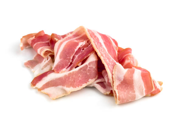 istock Slices of bacon on a white background. Raw bacon closeup on a white background. 1129197877