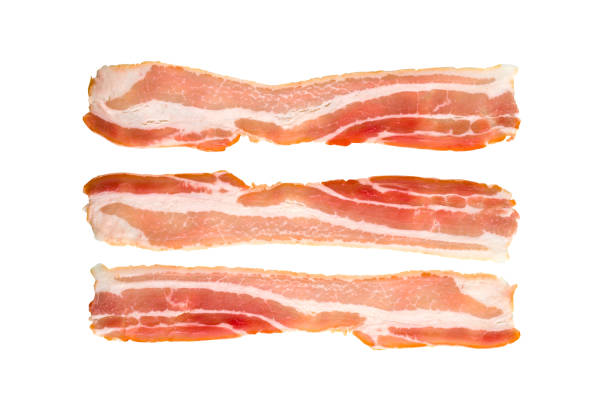 A slice of bacon on a white background. Three raw bacon close up on a white background. A slice of bacon on a white background. Three raw bacon close up on a white background. twisted bacon stock pictures, royalty-free photos & images