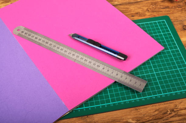 istock Ruler and utility knife on coloured paper 1129199535